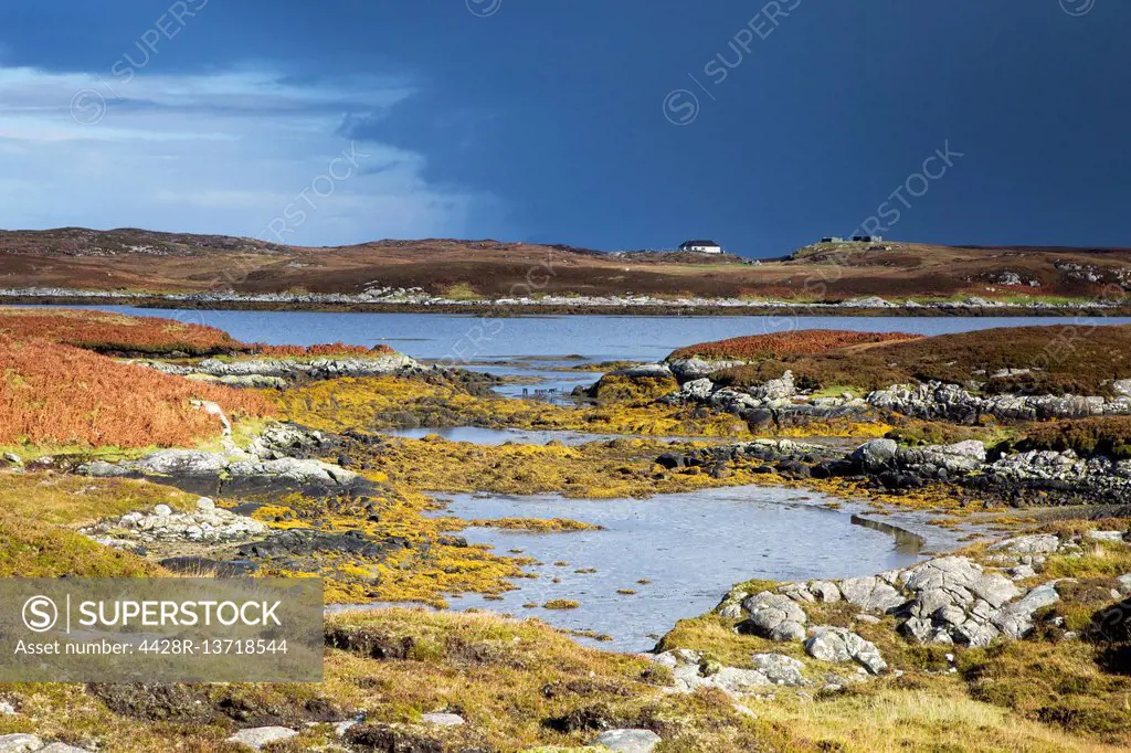 Sunny tranquil view craggy rocks and lake, Loch Euphoirt, North Uist, Outer Hebrides