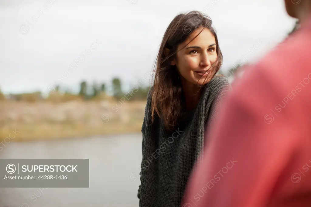 Cape Town, Smiling woman looking at man at lakeside