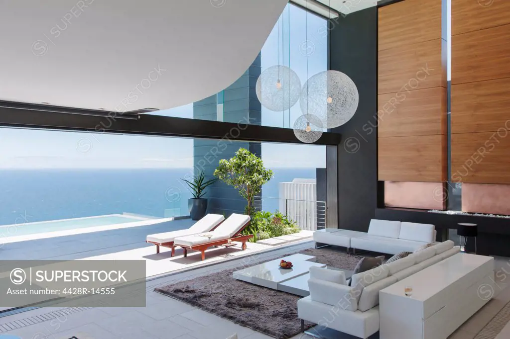 Living room and patio of modern house overlooking ocean, Cape Town, South Africa