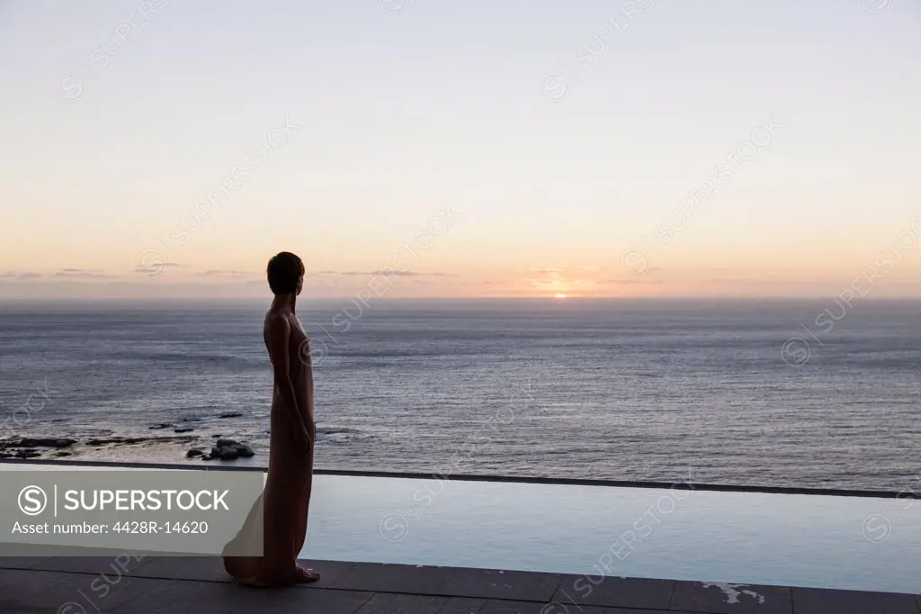Woman looking at ocean from patio, Cape Town, South Africa