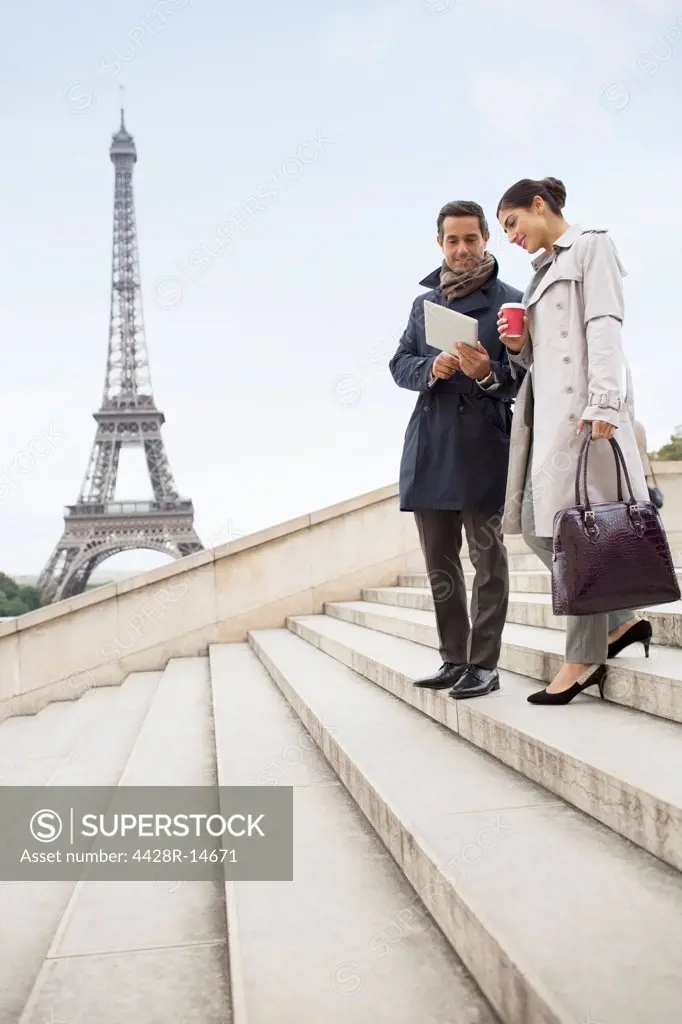 Business people talking on steps near Eiffel Tower, Paris, France, Paris, France