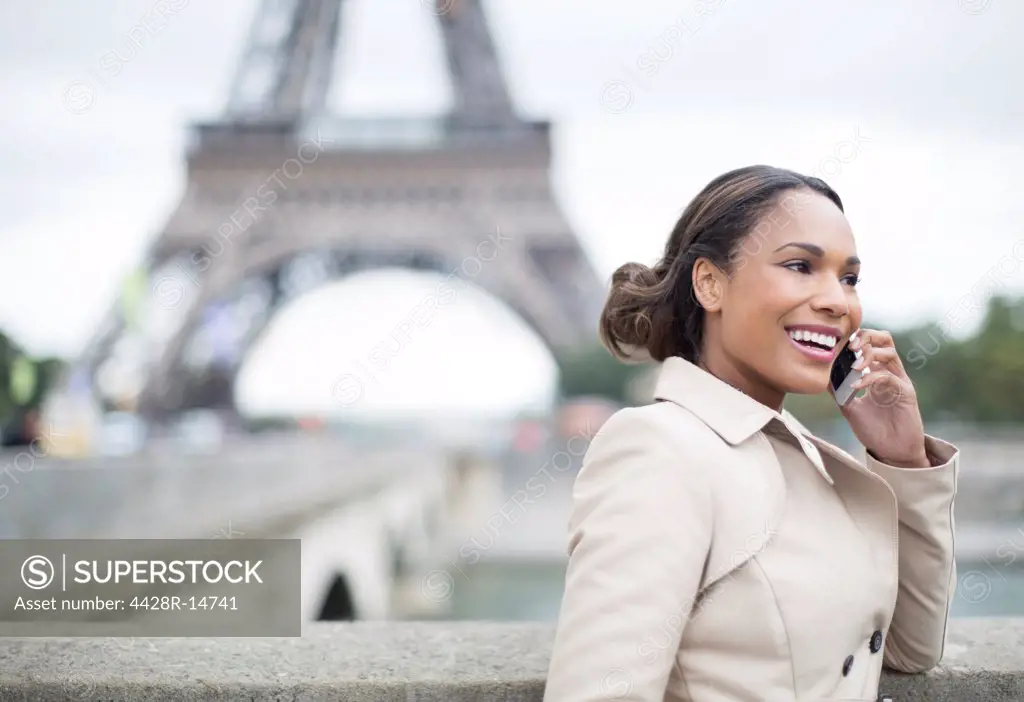 Businesswoman talking on cell phone near Eiffel Tower, Paris, France, Paris, France