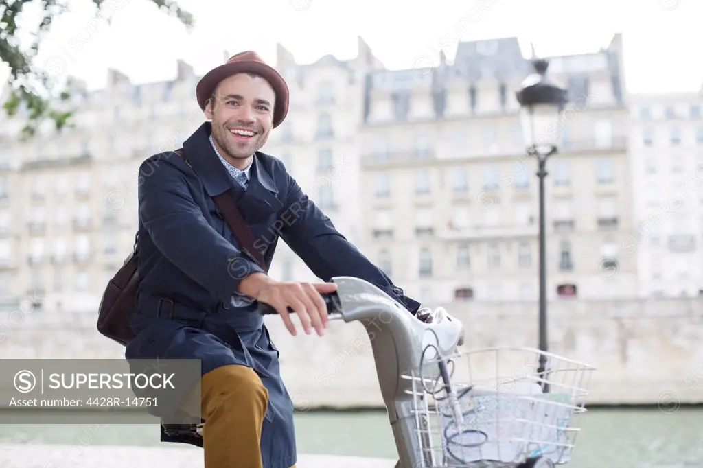 Businessman on bicycle along Seine River, Paris, France, Paris, France
