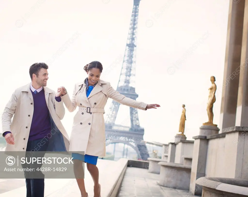 Couple walking in front of Eiffel Tower, Paris, France, Paris, France