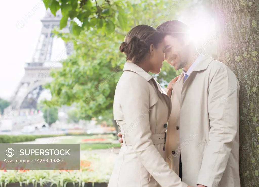 Couple kissing in park near Eiffel Tower, Paris, France, Paris, France