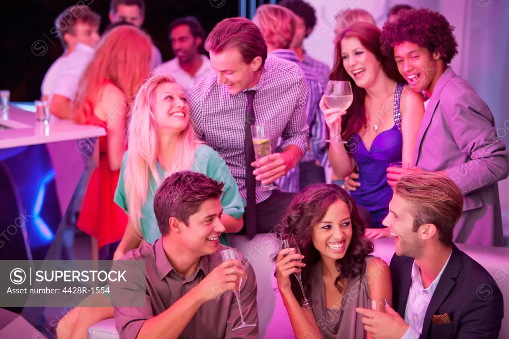 Cape Town, Smiling friends drinking champagne in nightclub