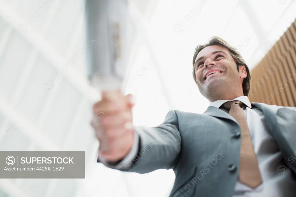 Spain, Smiling businessman shaking hands with businesswoman