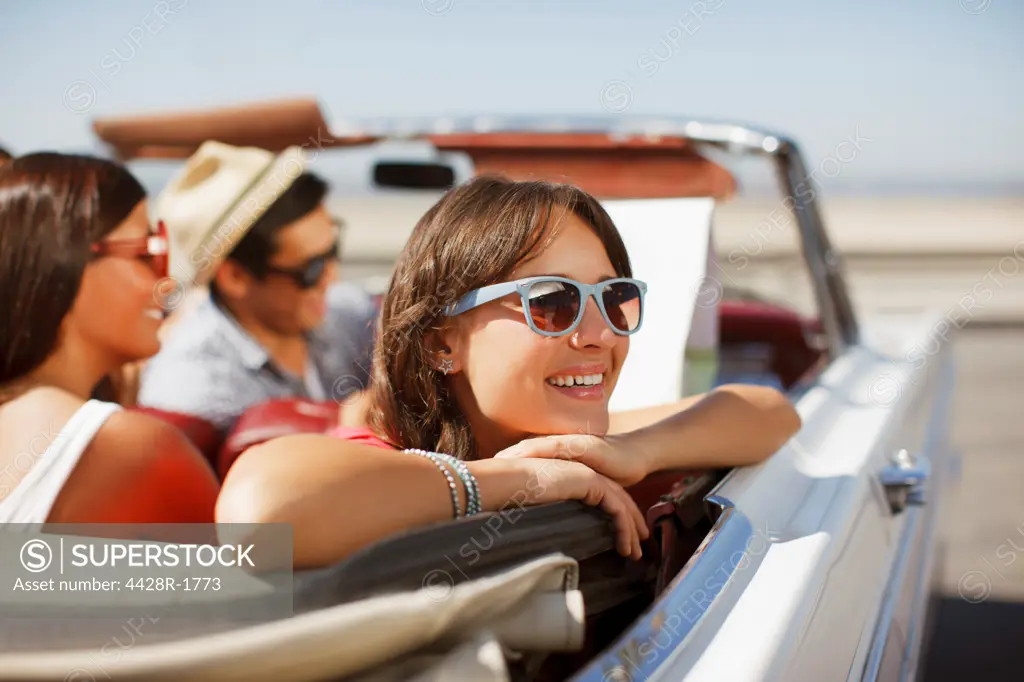 Los Angeles, USA, Smiling woman leaning out convertible