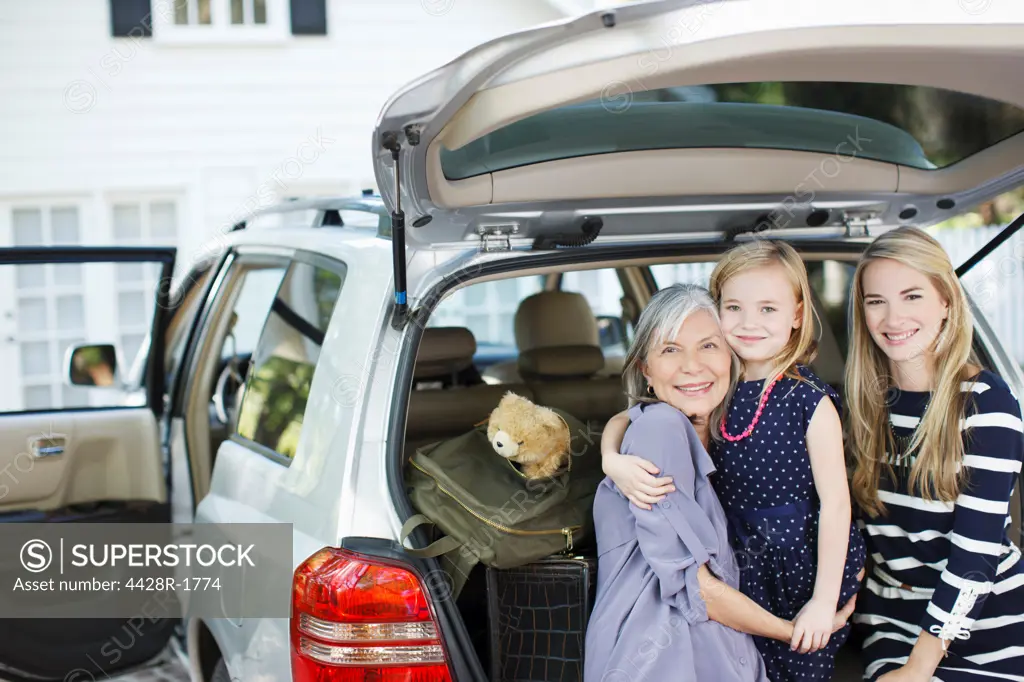 Los Angeles, USA, Three generations of women sitting in trunk