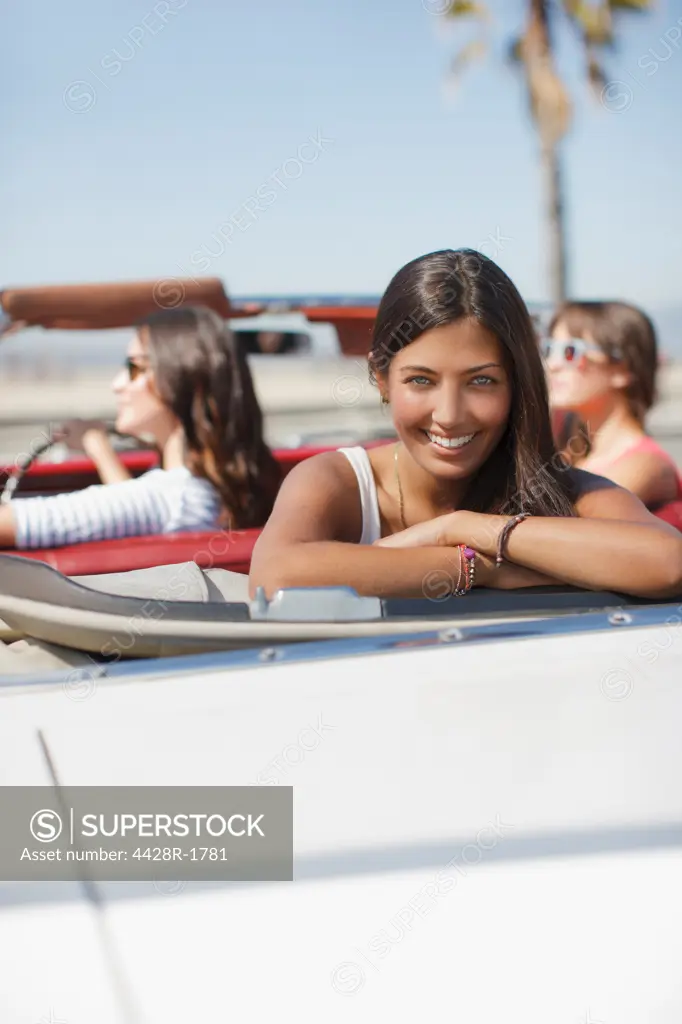 Los Angeles, USA, Smiling woman sitting in convertible