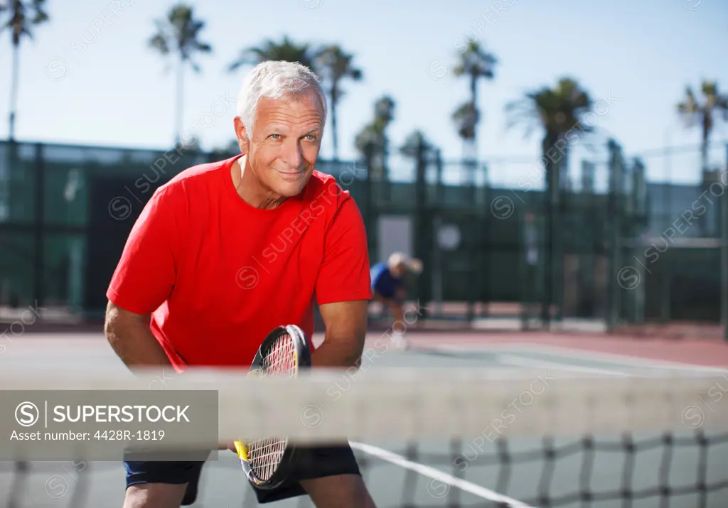 Los Angeles, USA, Older man playing tennis on court
