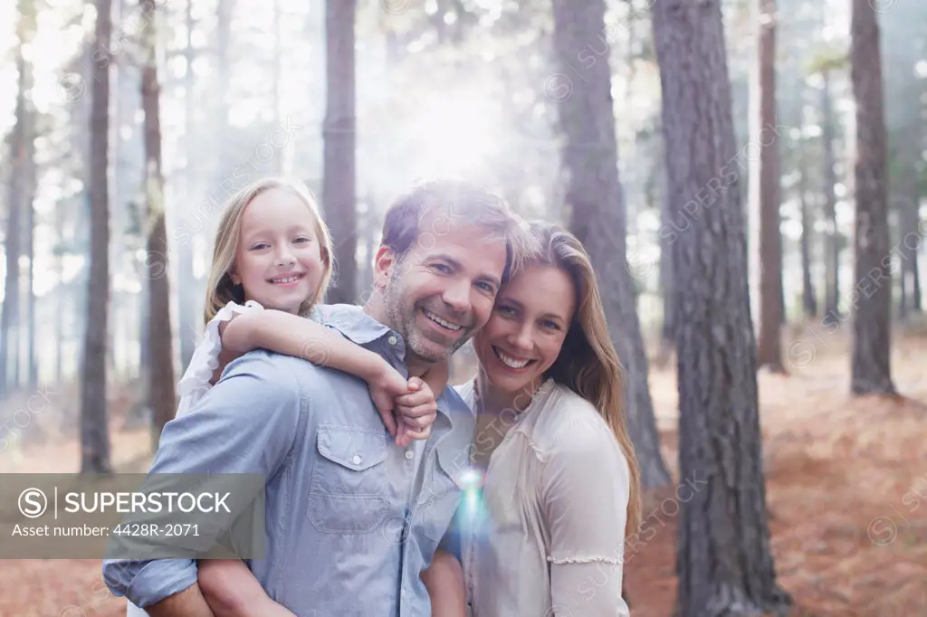 Cape Town, South Africa, Portrait of smiling family in sunny woods