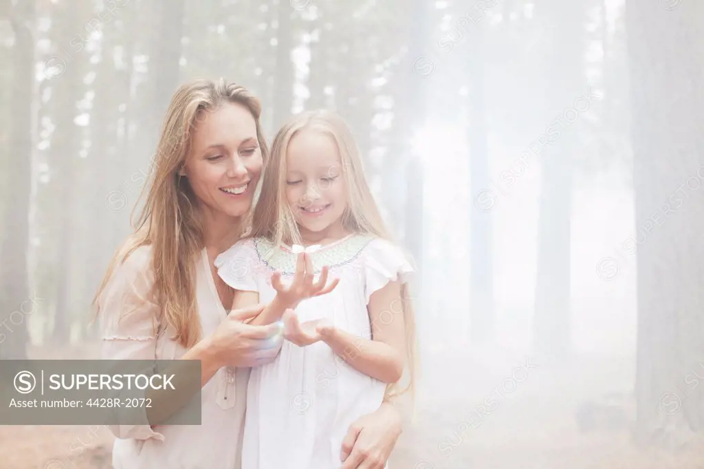 Cape Town, South Africa, Smiling mother and daughter in sunny woods