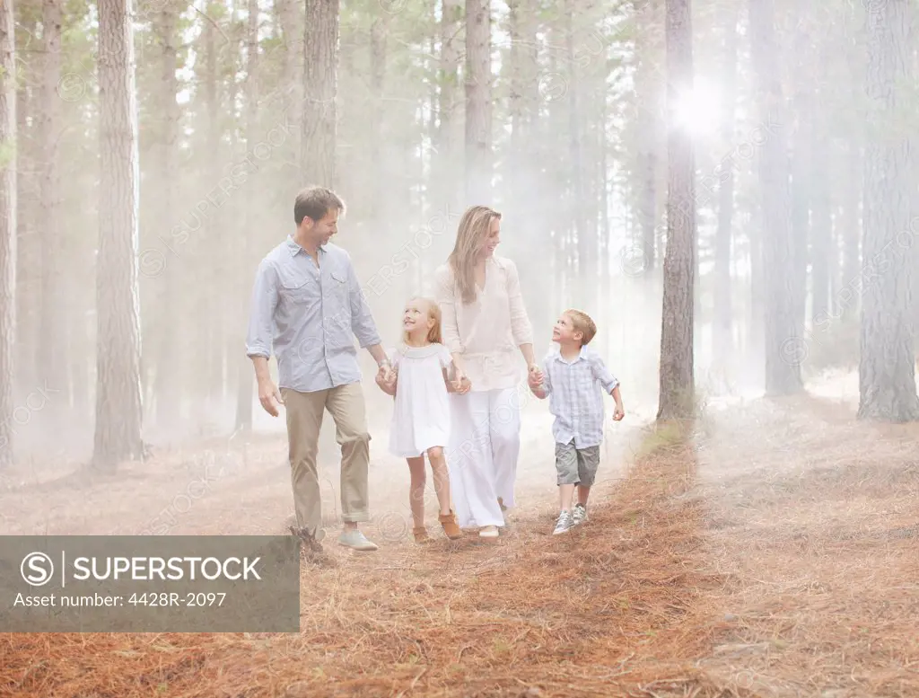Cape Town, South Africa, Happy family walking in sunny woods