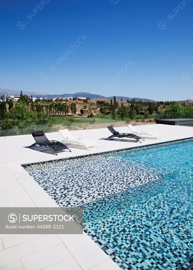 Spain, Lounge chairs and swimming pool