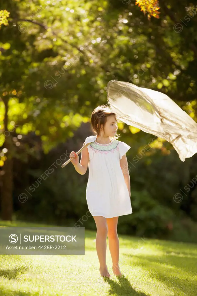Cape Town, Girl carrying butterfly net in grass