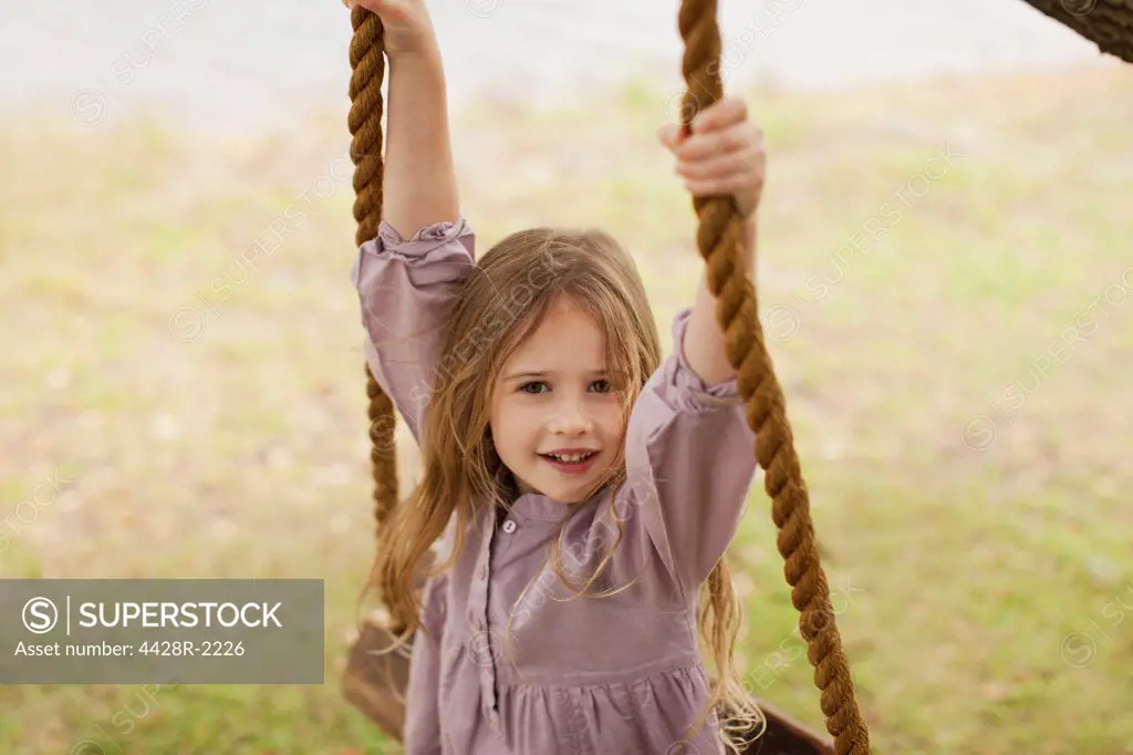 Cape Town, Portrait of smiling girl on swing