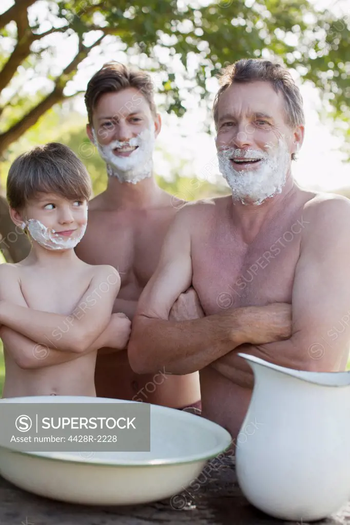 Cape Town, Portrait of multi-generation men with arms crossed and shaving cream on faces