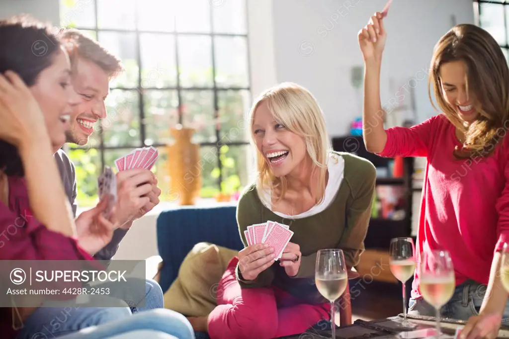 Friends playing card game in living room,Hamburg, Germany