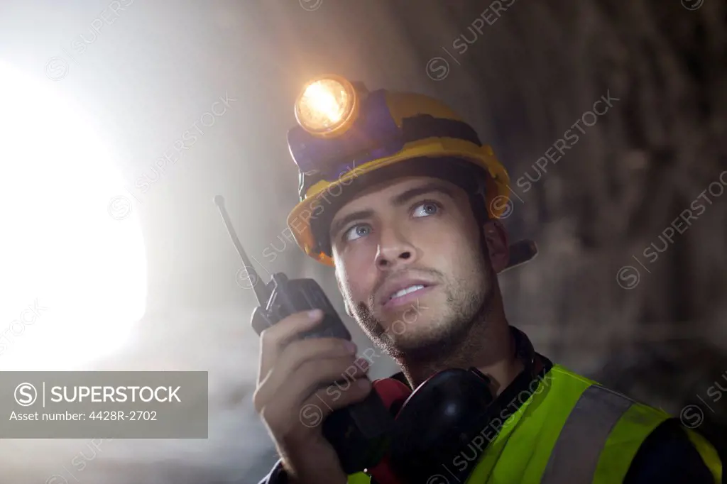 Worker using walkie-talkie in tunnel, Spain