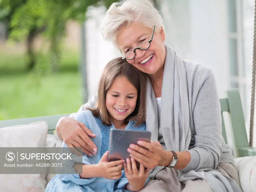 Woman and granddaughter using digital tablet,Hamburg, Germany