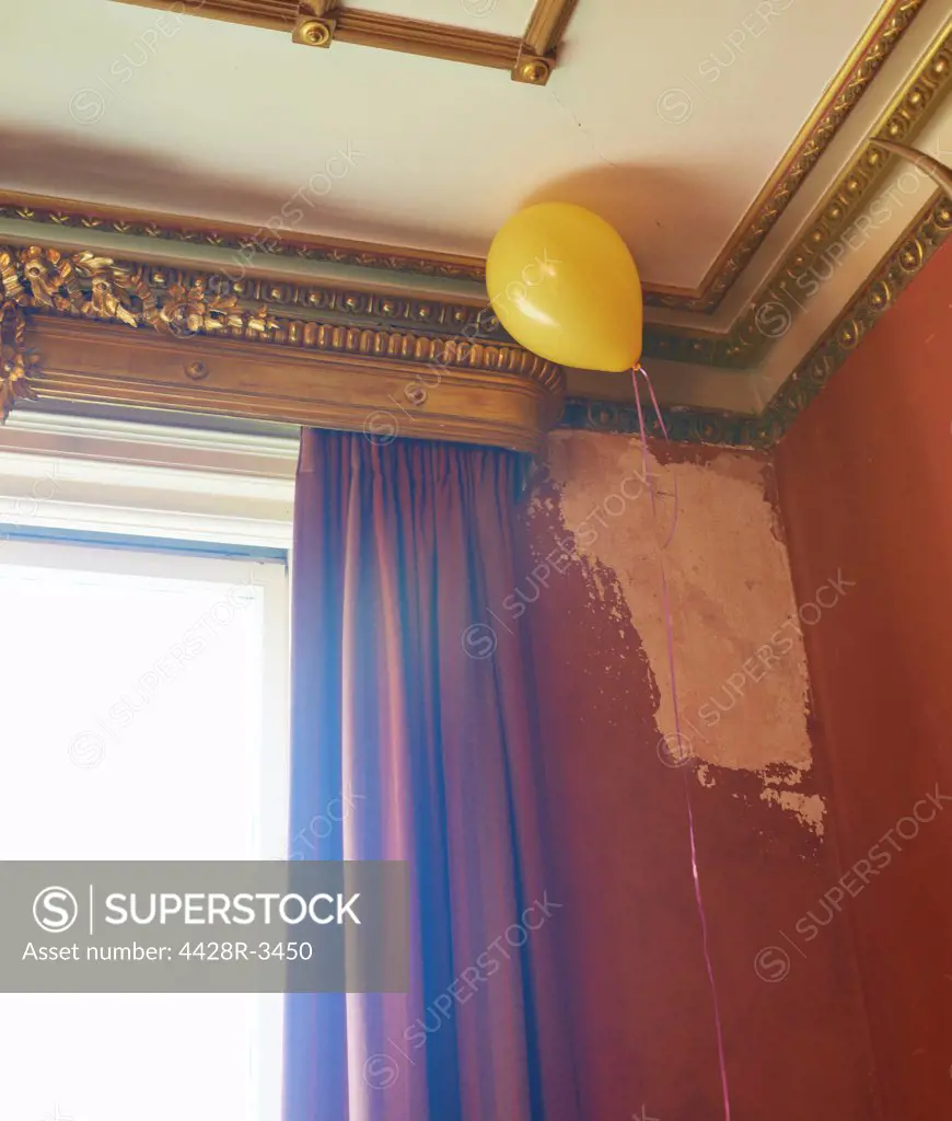 Balloon floating in corner of ornate room,belmonthouse, UK