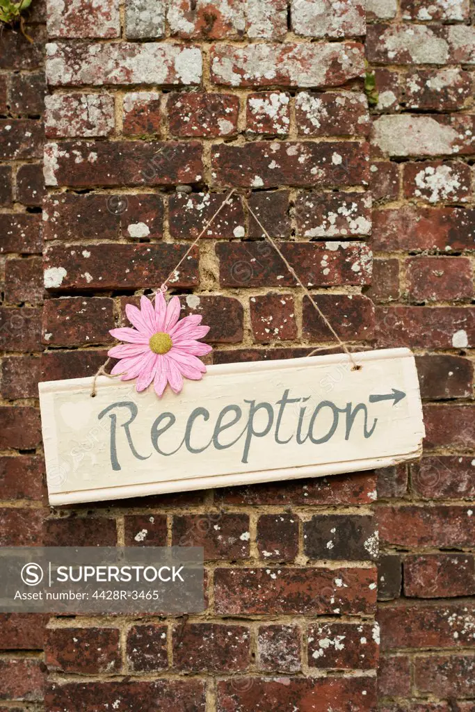 Reception' sign on brick wall,belmonthouse, UK