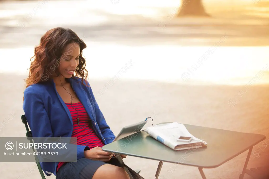 Woman using digital tablet in park,New York