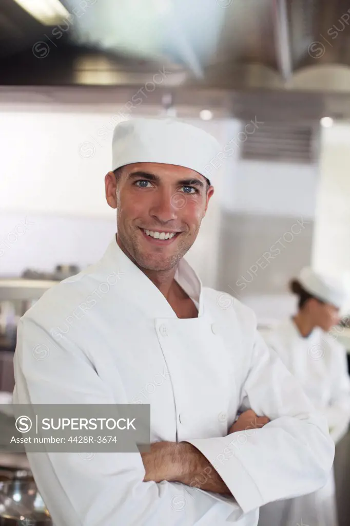 Chef smiling in restaurant kitchen, Spain