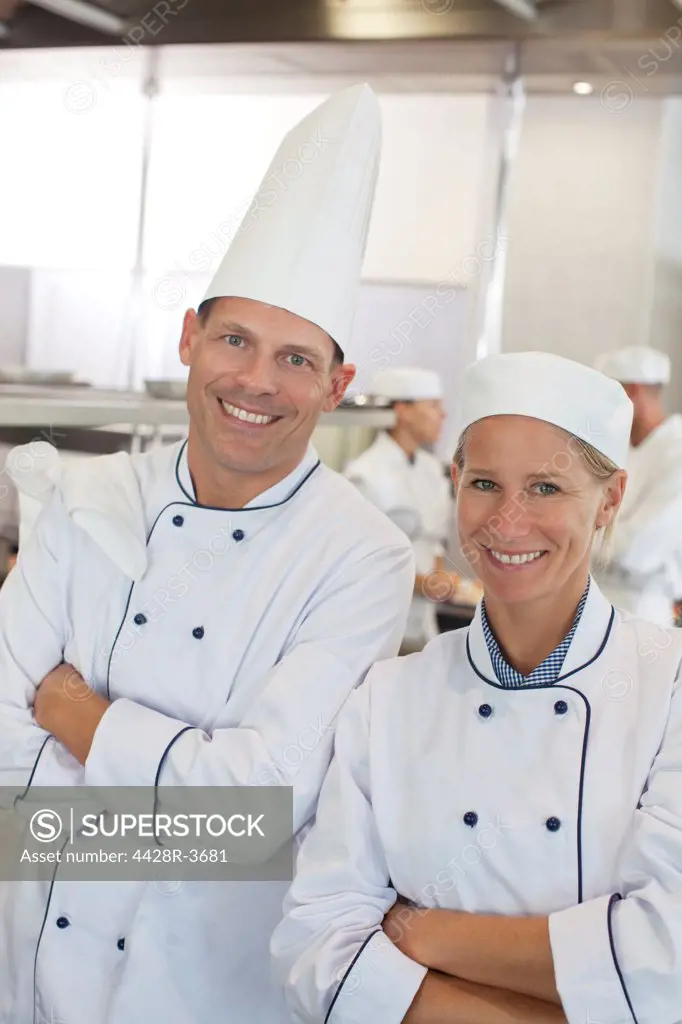 Chefs smiling in restaurant kitchen, Spain