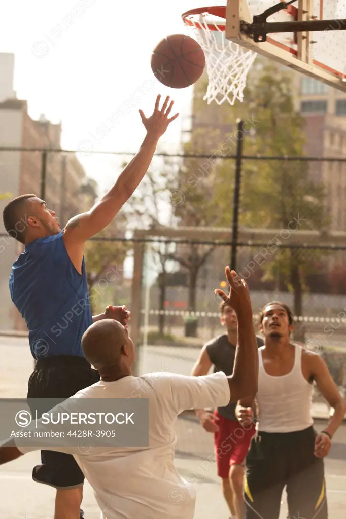 Men playing basketball on court,New York