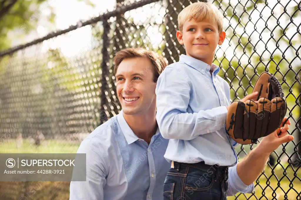 Father and son in baseball field,New York