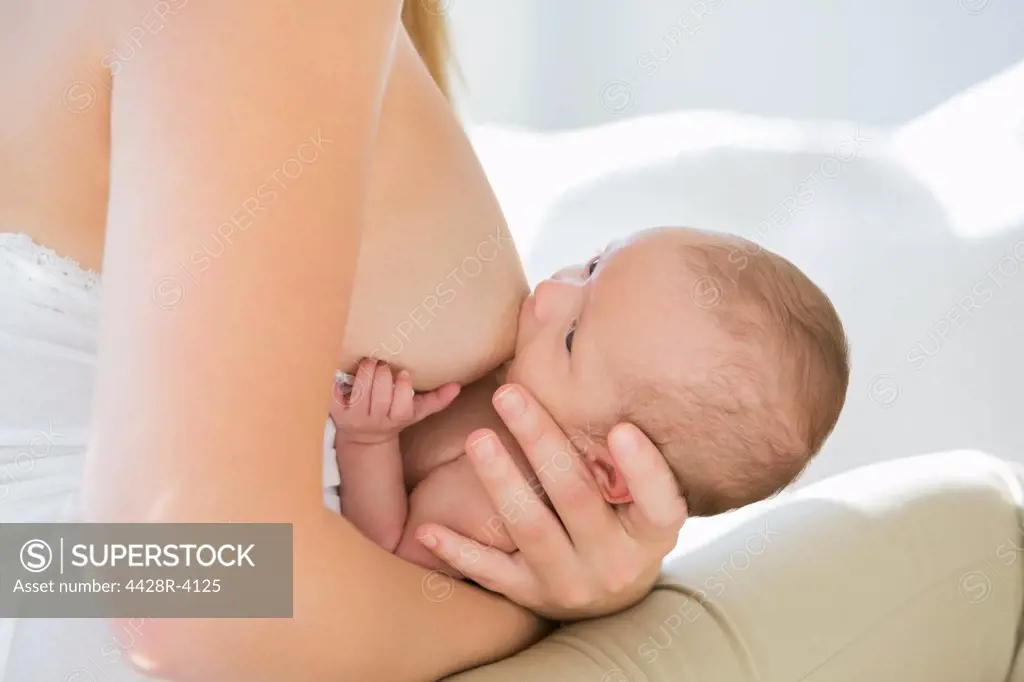 Mother breastfeeding newborn baby,London, UK