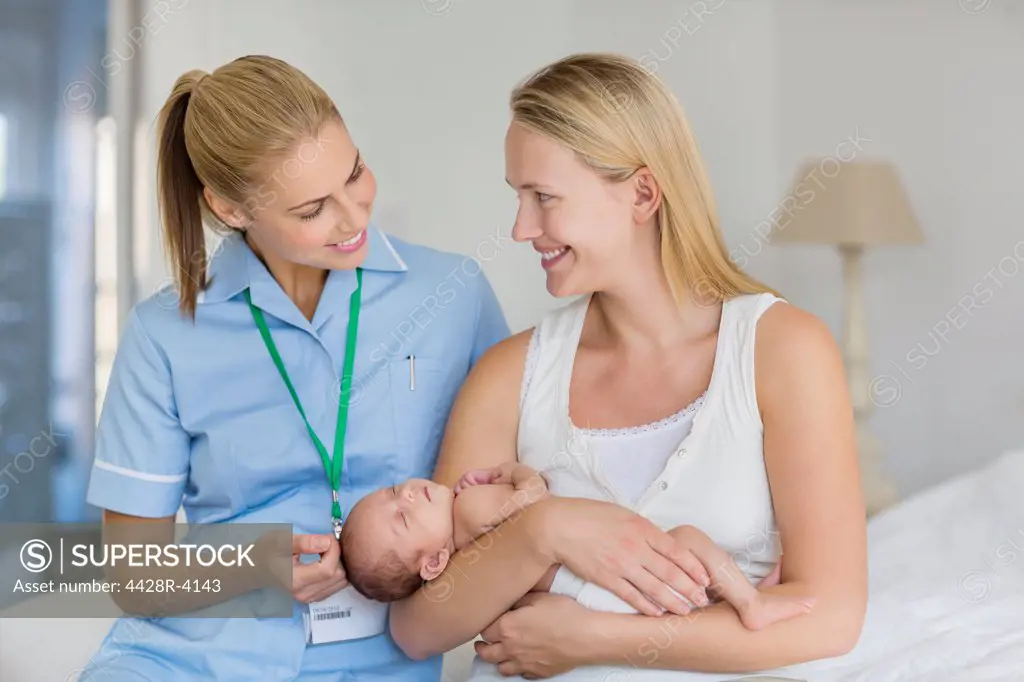 Mother and nurse with newborn baby,London, UK