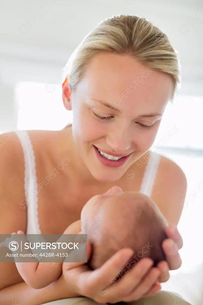 Mother cradling newborn baby,London, UK