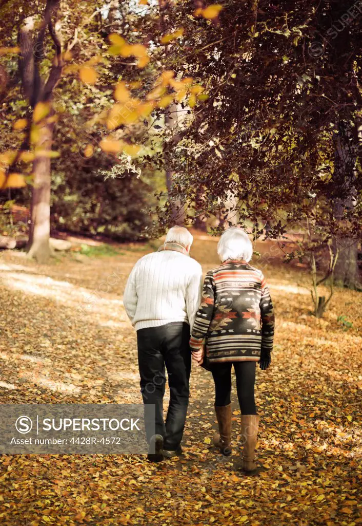 Older couple walking together in park,London, UK