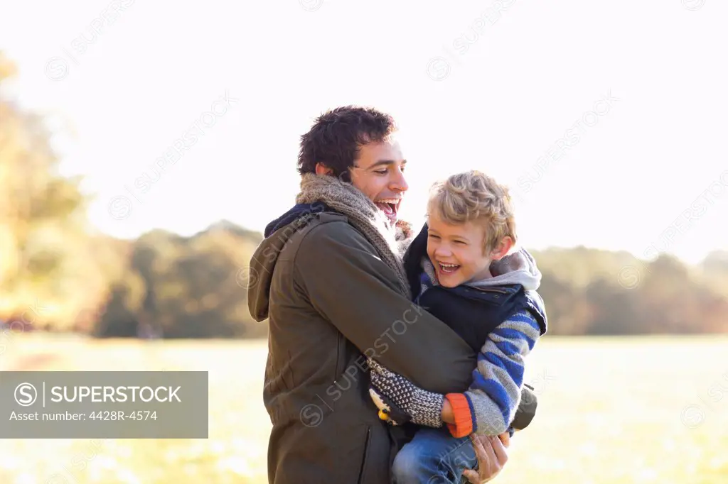 Father and son playing outdoors,London, UK