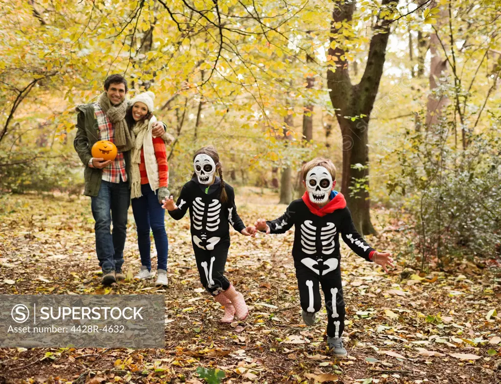 Children in skeleton costumes playing in park,London, UK