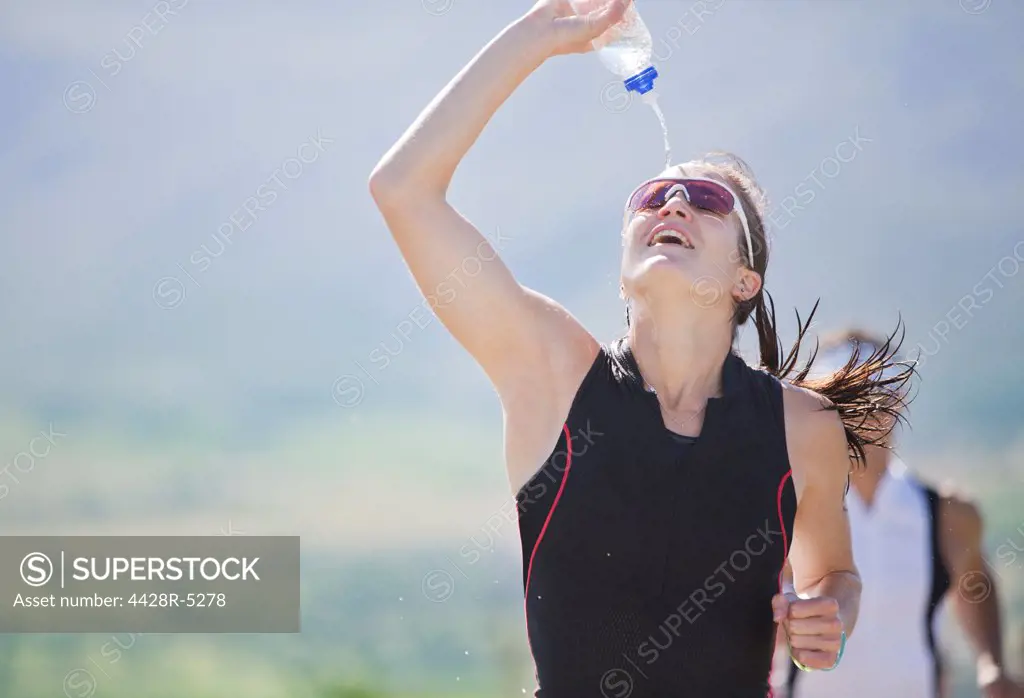 Runner spraying water in race