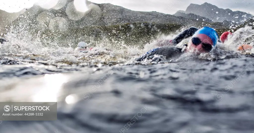 Swimmers splashing in water