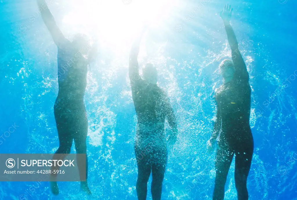 Athletes swimming underwater