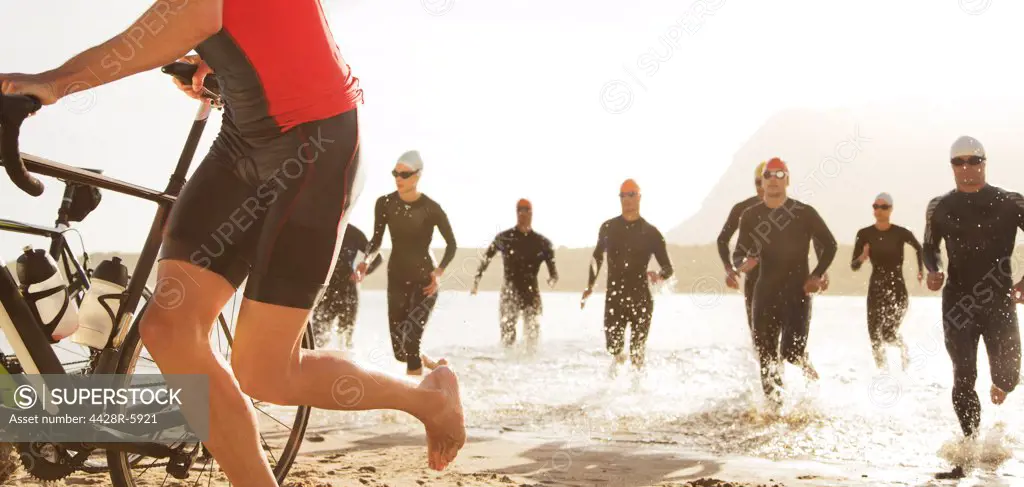 Triathletes emerging from water