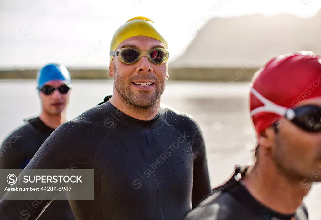 Triathletes in wetsuit smiling in water