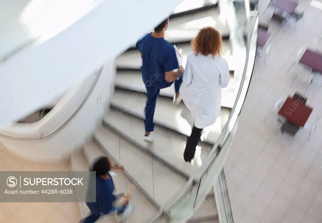 Hospital staff climbing spiral steps