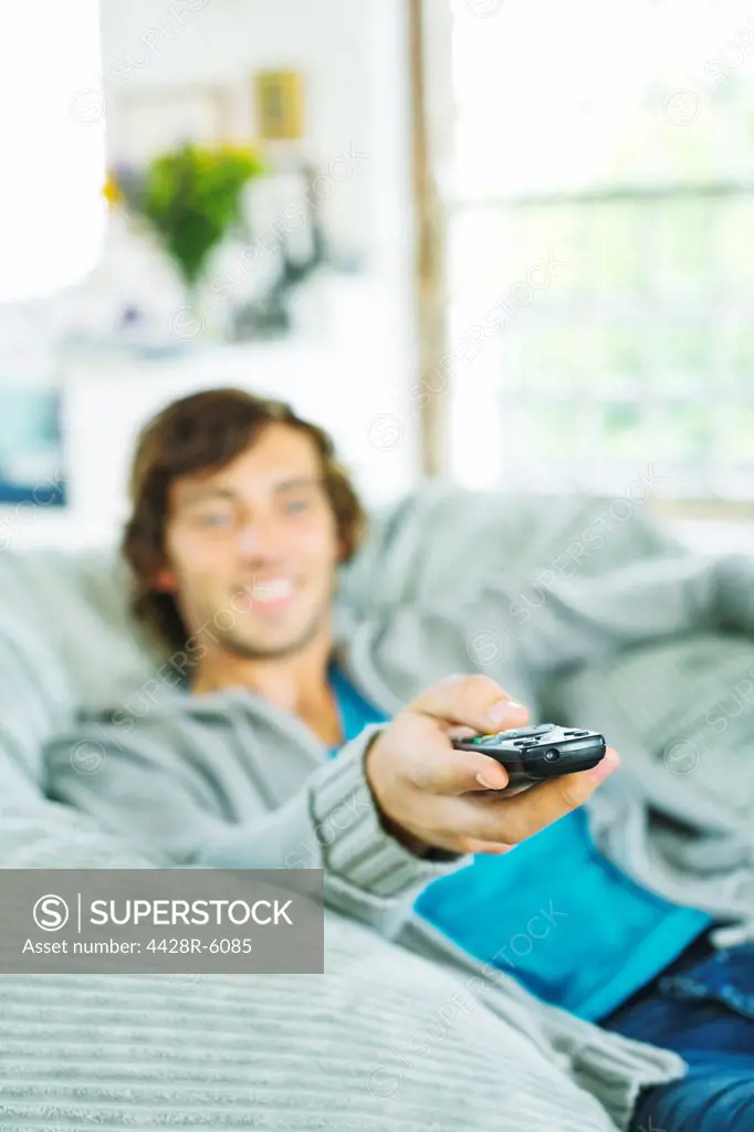 Man watching television in beanbag chair