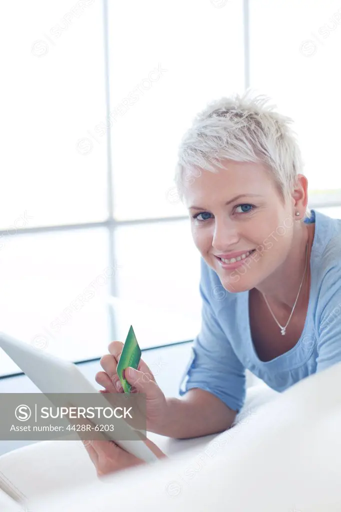 Woman shopping online with tablet computer