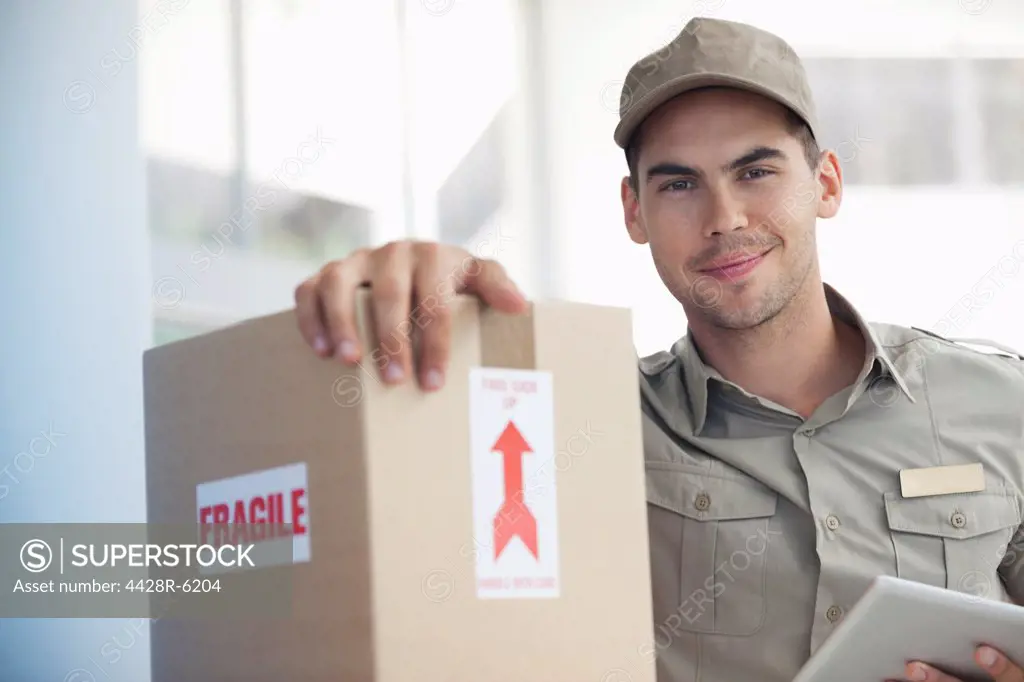 Delivery boy carrying fragile’ package