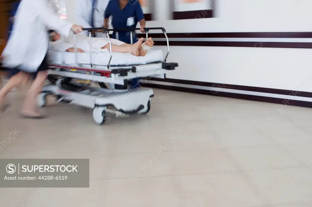 Hospital staff rushing patient to operating room