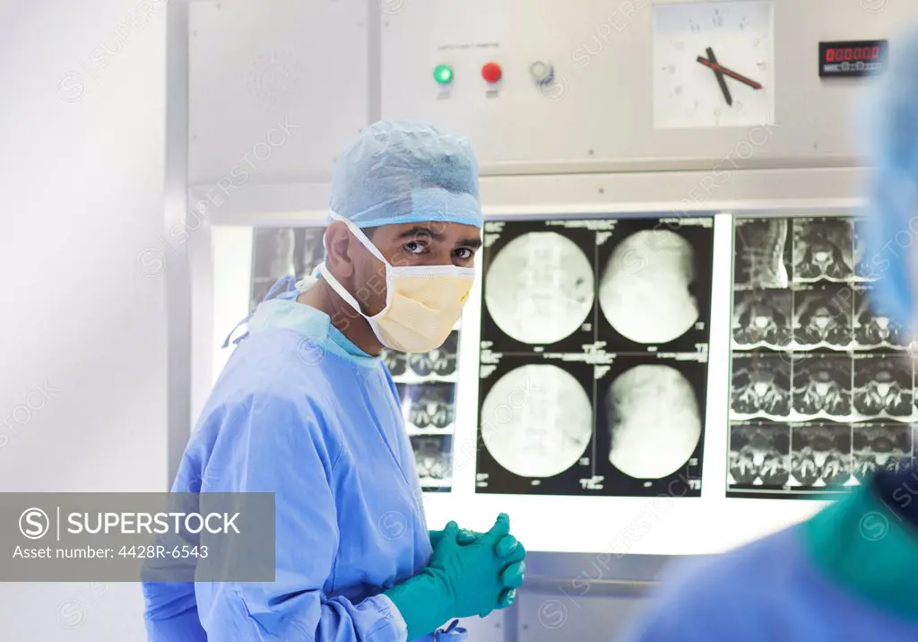 Surgeon examining x-rays in operating room