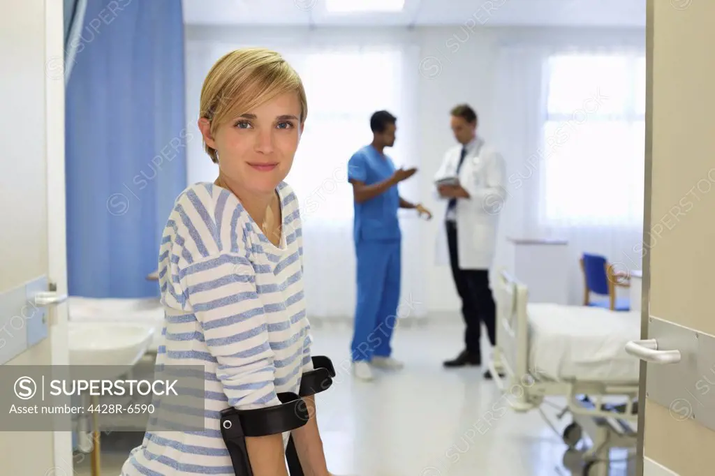 Patient using crutches in hospital room